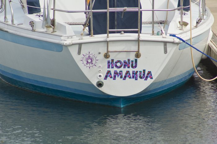 boat named Honu Amakua in mulicolor type