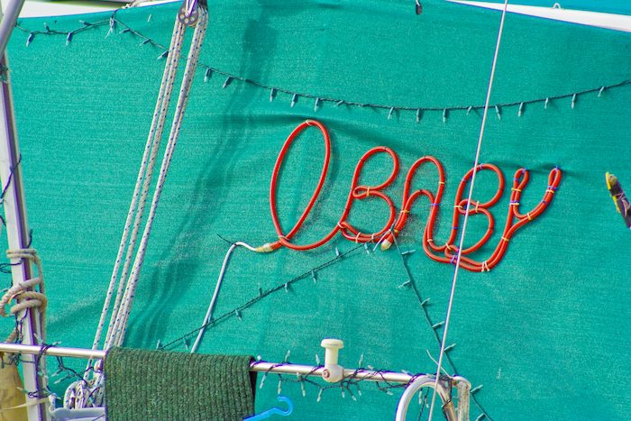 boat named O Baby spelled with waterproof string of lights