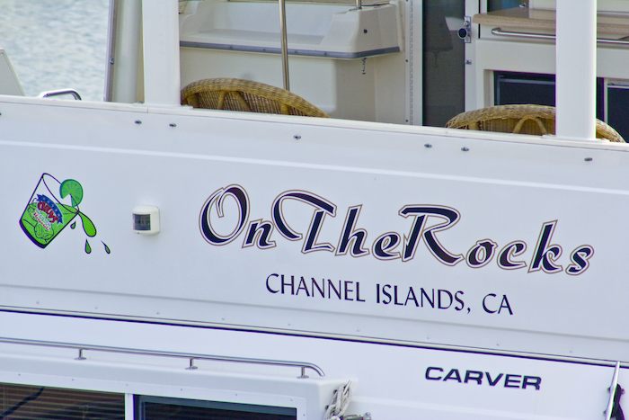 boat named On the Rocks with picture of an alcoholic beverage
