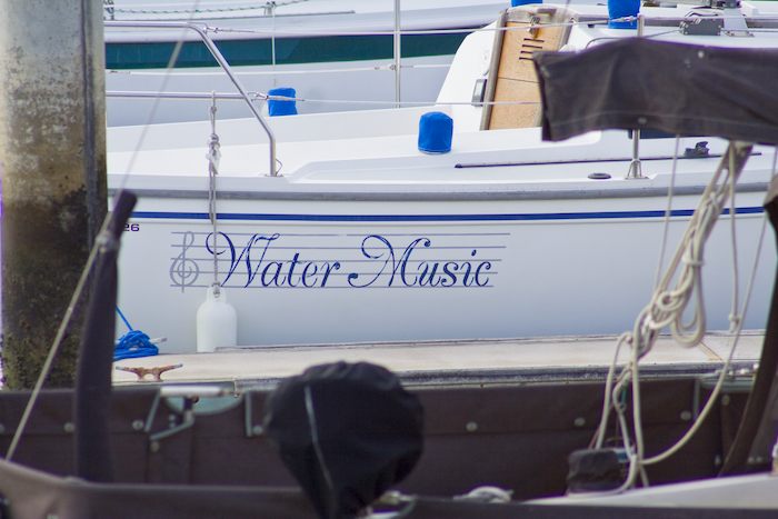 boat named Water Music painted ontop of music notes